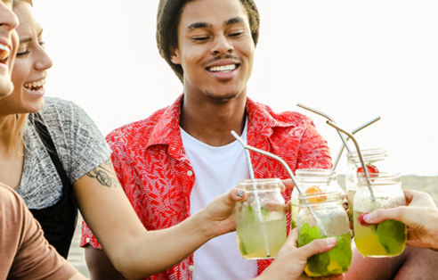 group-of-friends-drinking-fruit-infused-water-on-the-beach-having-a-picnic; shutterstock: 1218958036