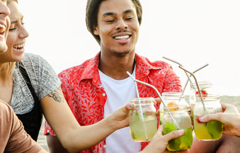 group-of-friends-drinking-fruit-infused-water-on-the-beach-having-a-picnic; shutterstock: 1218958036 