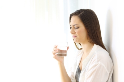 Disgusted woman drinking water with bad taste isolated on white at side; Shutterstock ID 758208634