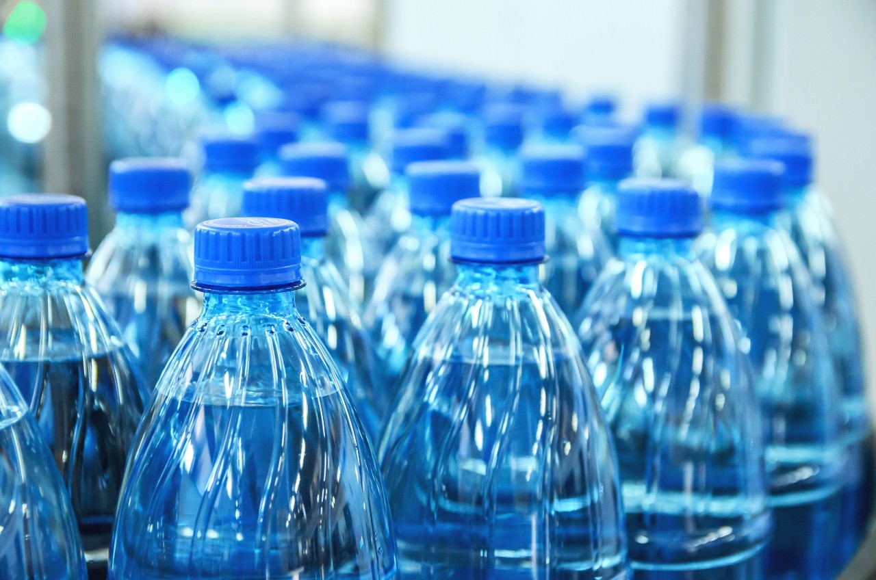 Closeup on mineral water bottles in row and lines