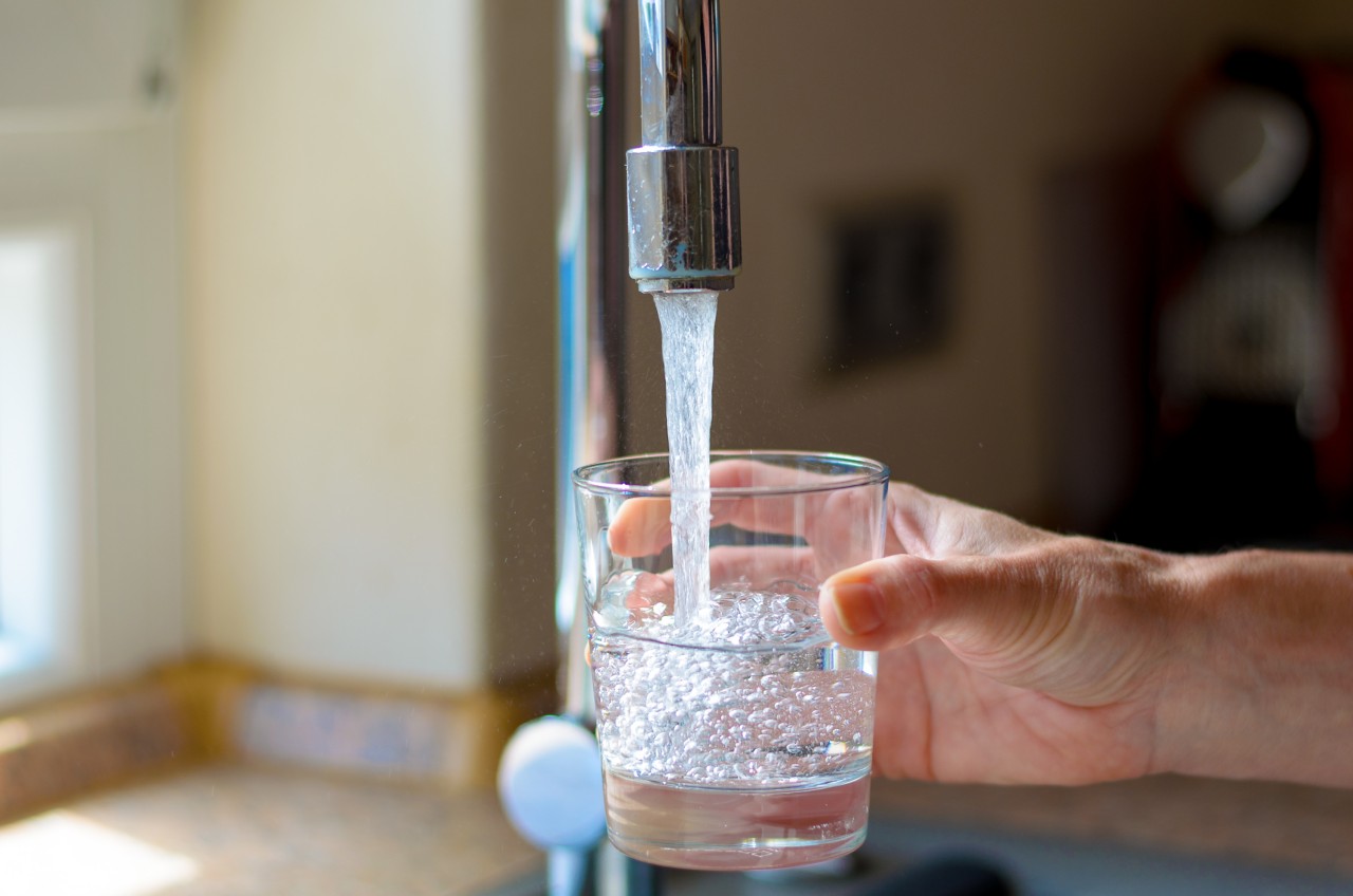 filling water glass under faucet
