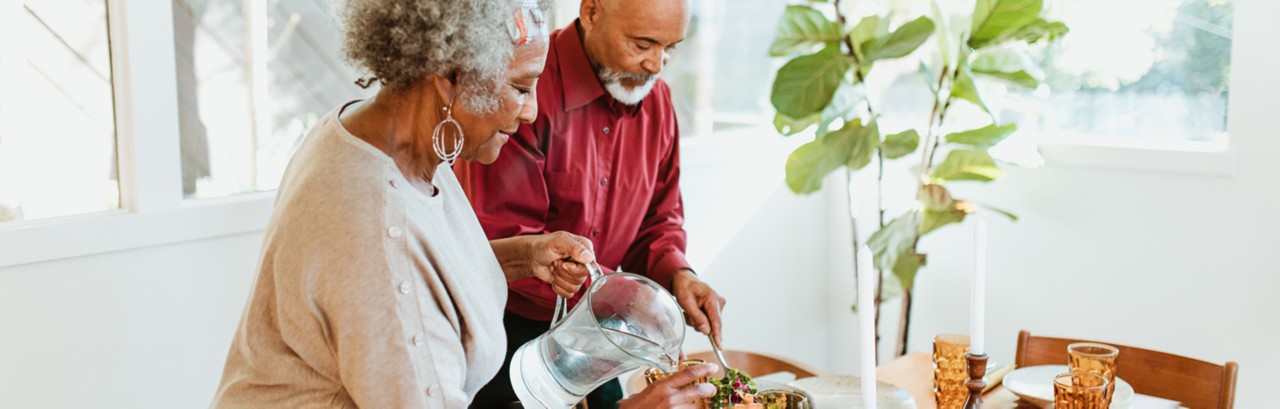 elder couple pouring water