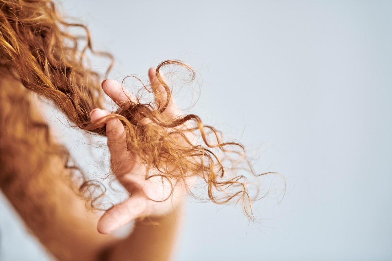 woman holding frizzy hair up
