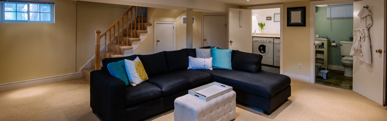 Hero Image Interior of modern renovated lover floor basement common room in private city residence.