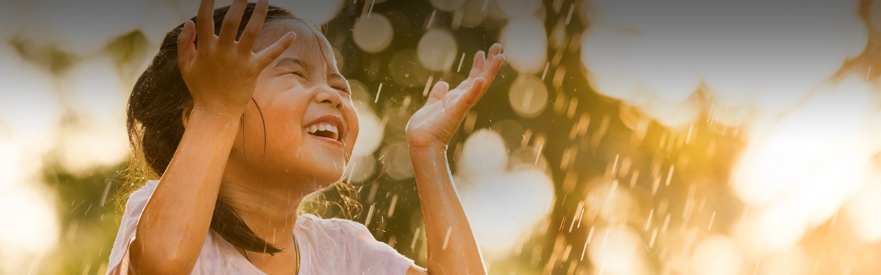 girl getting wet with raindrops