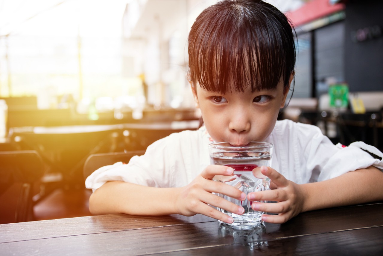 Hands Around Water Glass image